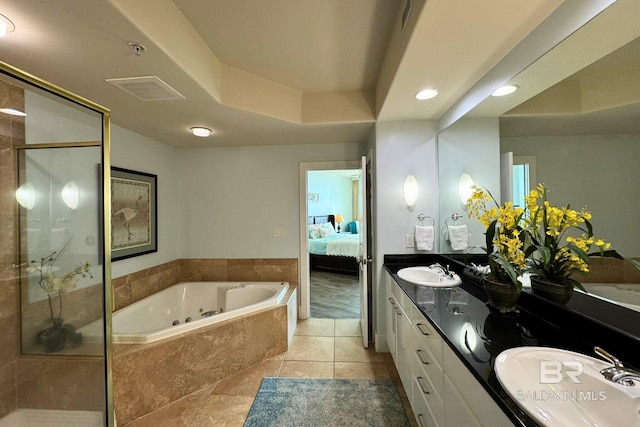 ensuite bathroom with a whirlpool tub, a shower stall, a sink, and ensuite bathroom