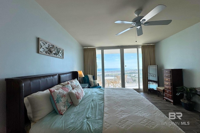 bedroom with access to exterior, a ceiling fan, a wall of windows, and wood finished floors