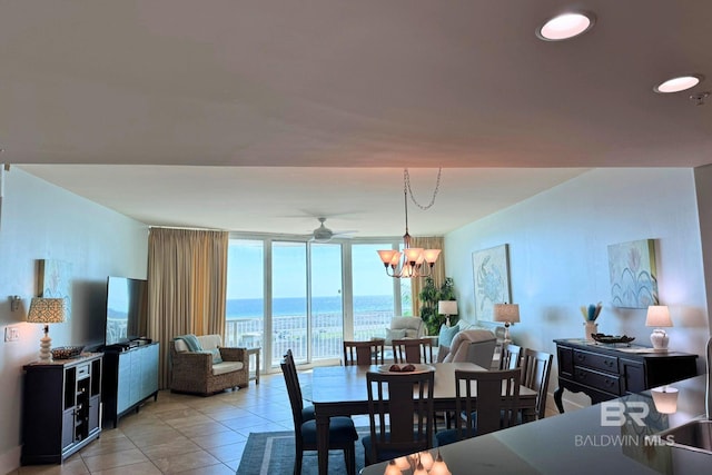 dining room featuring light tile patterned floors, ceiling fan with notable chandelier, and floor to ceiling windows