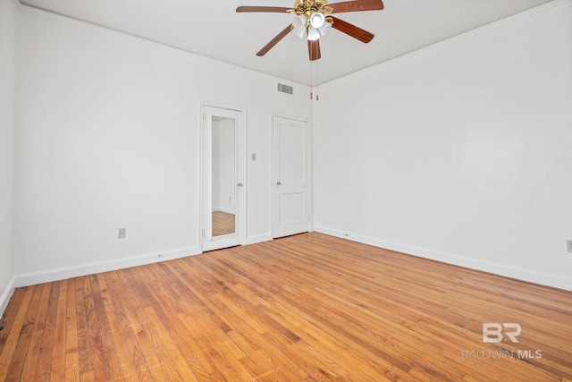 unfurnished bedroom with light wood-style floors, visible vents, and baseboards