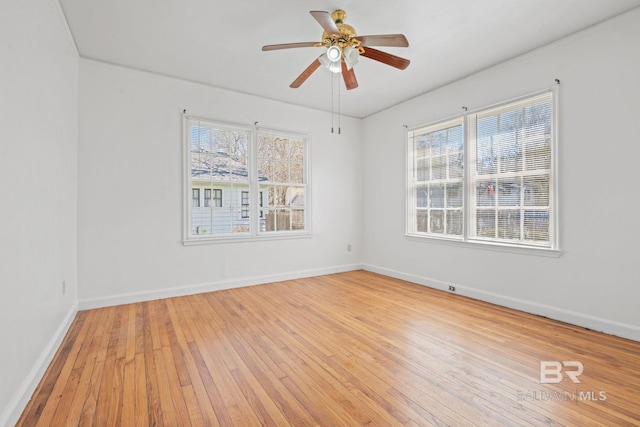 unfurnished room featuring a ceiling fan, baseboards, and hardwood / wood-style floors