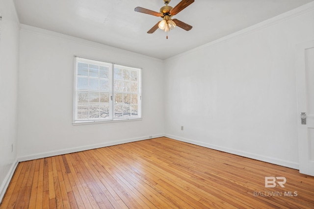 empty room with baseboards, a ceiling fan, hardwood / wood-style floors, and crown molding