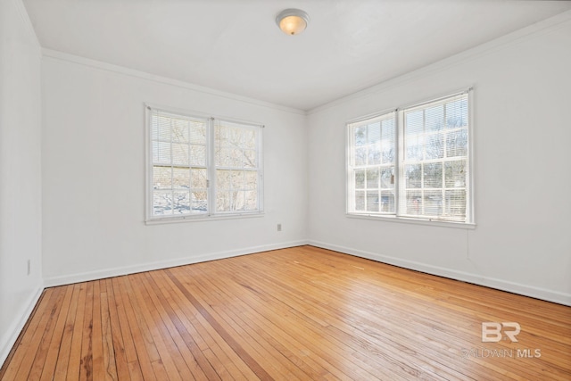 unfurnished room featuring baseboards, wood-type flooring, and ornamental molding