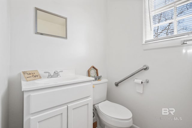 bathroom featuring toilet and vanity