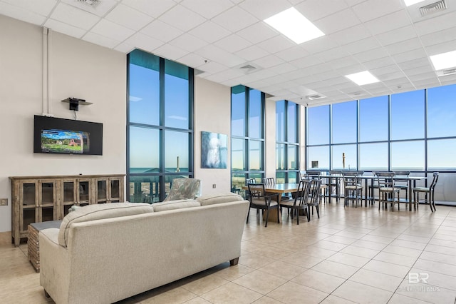24230 Perdido Beach Blvd Unit 3077, Orange Beach, AL 36561 - living room featuring visible vents, light tile patterned floors, a wall of windows, and a towering ceiling