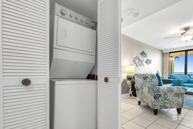 24230 Perdido Beach Blvd Unit 3077, Orange Beach, AL 36561 - washroom featuring laundry area, ceiling fan, light tile patterned flooring, stacked washer and clothes dryer, and baseboards