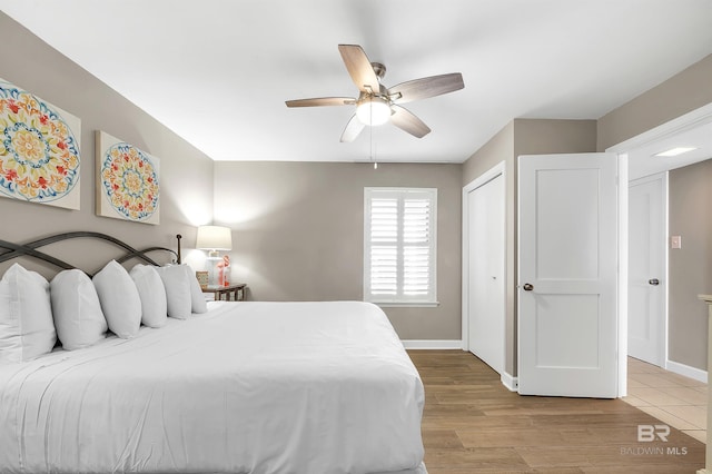 24230 Perdido Beach Blvd Unit 3077, Orange Beach, AL 36561 - bedroom featuring wood finished floors, ceiling fan, baseboards, and a closet