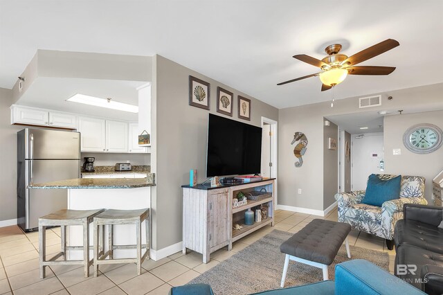 24230 Perdido Beach Blvd Unit 3077, Orange Beach, AL 36561 - living room with visible vents, ceiling fan, light tile patterned flooring, and baseboards