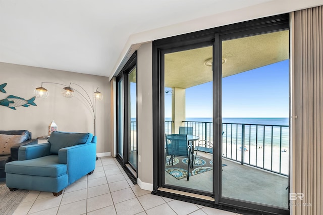 24230 Perdido Beach Blvd Unit 3077, Orange Beach, AL 36561 - living area featuring a view of the beach, light tile patterned floors, baseboards, and a water view