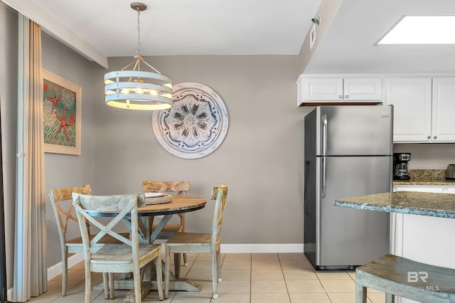 24230 Perdido Beach Blvd Unit 3077, Orange Beach, AL 36561 - dining room featuring light tile patterned floors, baseboards, and an inviting chandelier