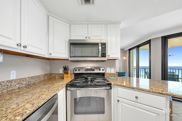 24230 Perdido Beach Blvd Unit 3077, Orange Beach, AL 36561 - kitchen featuring white cabinets, appliances with stainless steel finishes, and visible vents