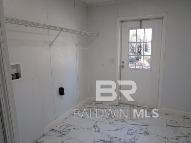 laundry room featuring washer hookup, laundry area, marble finish floor, and baseboards