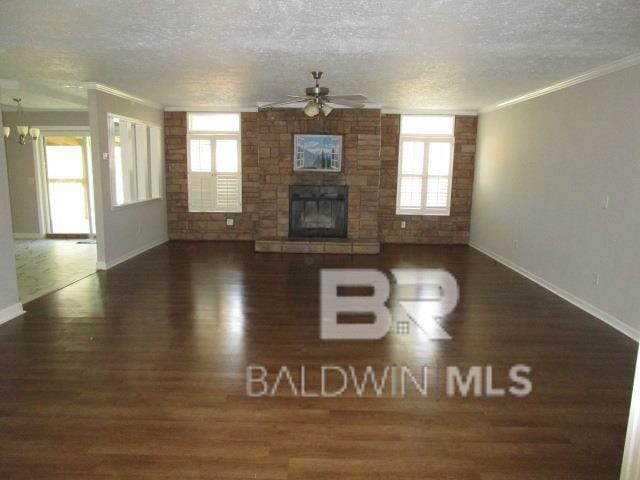 unfurnished living room with a healthy amount of sunlight, a fireplace, and ornamental molding