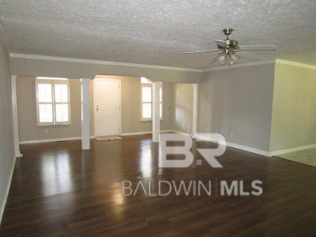 interior space with ornamental molding, dark wood-type flooring, and arched walkways