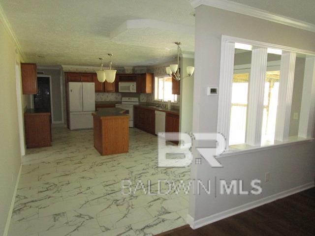 kitchen featuring marble finish floor, white appliances, and pendant lighting