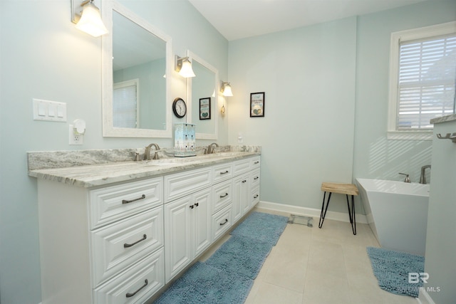 bathroom featuring a tub to relax in, tile patterned floors, and vanity