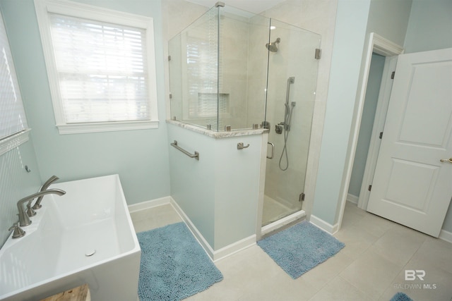 bathroom featuring separate shower and tub, tile patterned floors, and sink