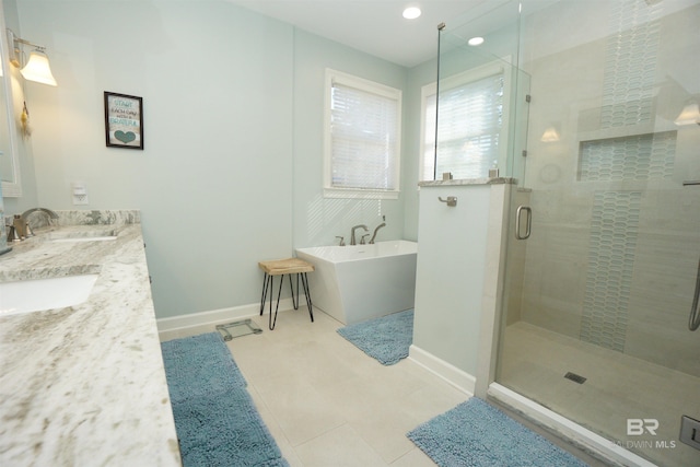 bathroom with vanity and shower with separate bathtub