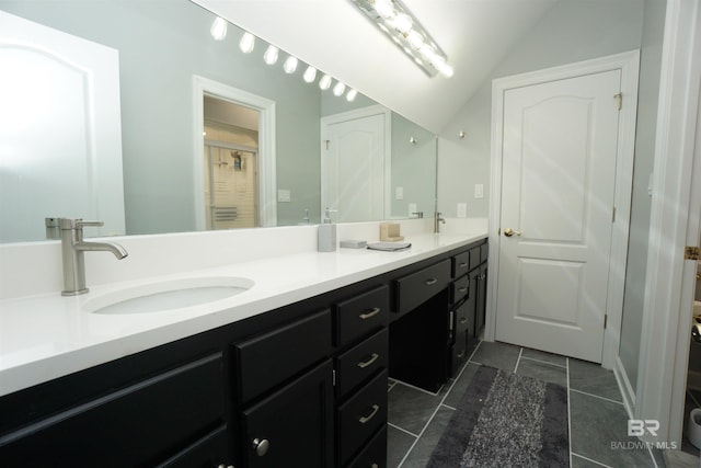 bathroom with vanity and lofted ceiling