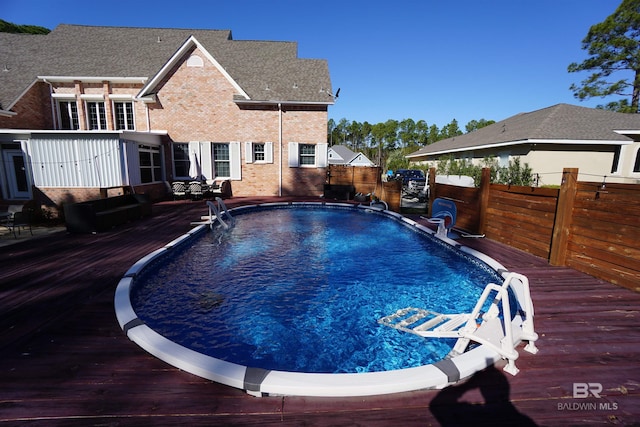 view of swimming pool with a deck