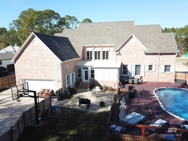 rear view of property with a pool side deck