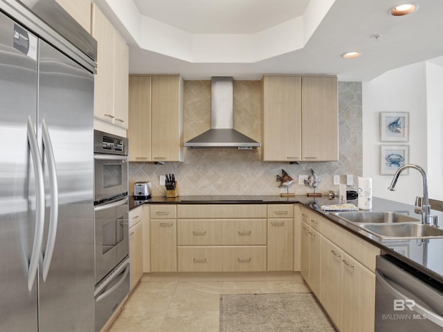 28105 Perdido Beach Blvd Unit C504, Orange Beach, AL 36561 - kitchen featuring wall chimney exhaust hood, stainless steel appliances, light brown cabinetry, a sink, and a warming drawer