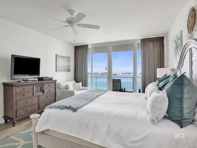28105 Perdido Beach Blvd Unit C504, Orange Beach, AL 36561 - bedroom featuring floor to ceiling windows, a water view, a ceiling fan, light wood-type flooring, and access to outside