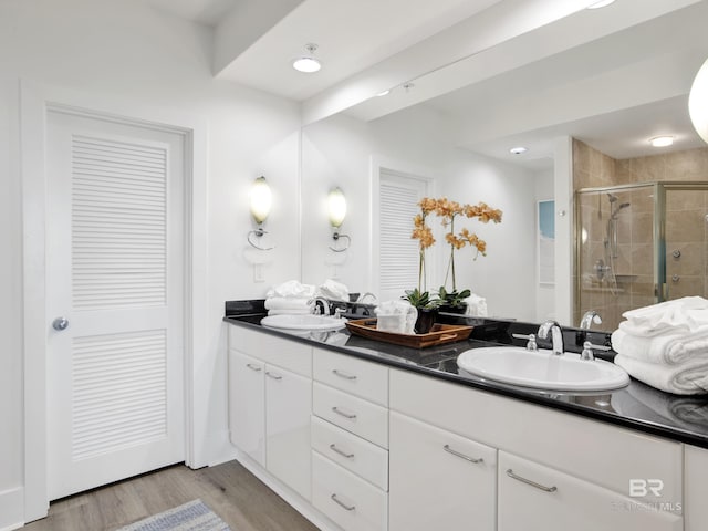 28105 Perdido Beach Blvd Unit C504, Orange Beach, AL 36561 - full bathroom with a shower stall, wood finished floors, a sink, and double vanity