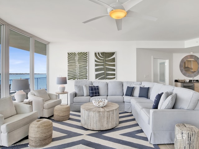 28105 Perdido Beach Blvd Unit C504, Orange Beach, AL 36561 - living room featuring a ceiling fan, floor to ceiling windows, and a water view