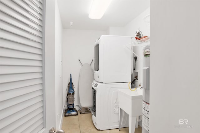 28105 Perdido Beach Blvd Unit C504, Orange Beach, AL 36561 - laundry room featuring stacked washer / drying machine, a sink, laundry area, and light tile patterned floors
