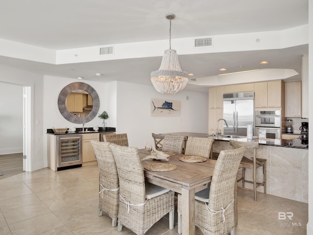 28105 Perdido Beach Blvd Unit C504, Orange Beach, AL 36561 - dining area featuring light tile patterned flooring, beverage cooler, visible vents, and a notable chandelier