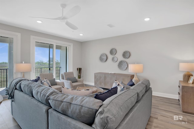 living area featuring recessed lighting, baseboards, ceiling fan, and light wood-type flooring