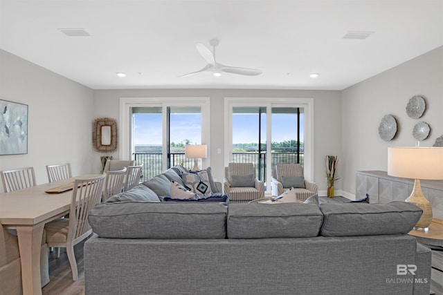 living room featuring recessed lighting, baseboards, ceiling fan, and wood finished floors