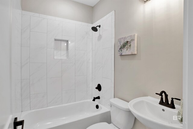 full bath with tub / shower combination, toilet, and a sink
