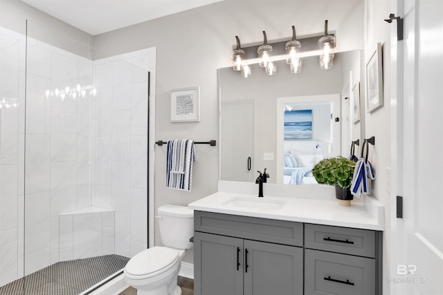 ensuite bathroom with toilet, tiled shower, vanity, a chandelier, and ensuite bath