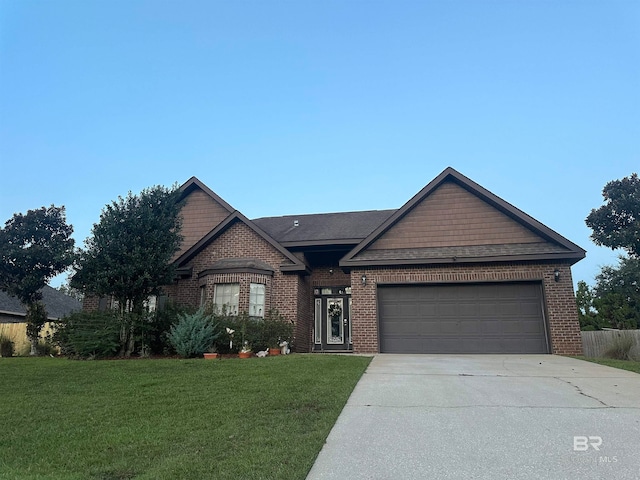 view of front of property with a front yard and a garage