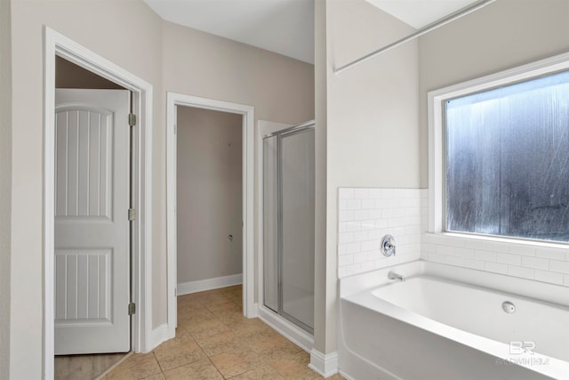 bathroom with independent shower and bath and tile patterned floors