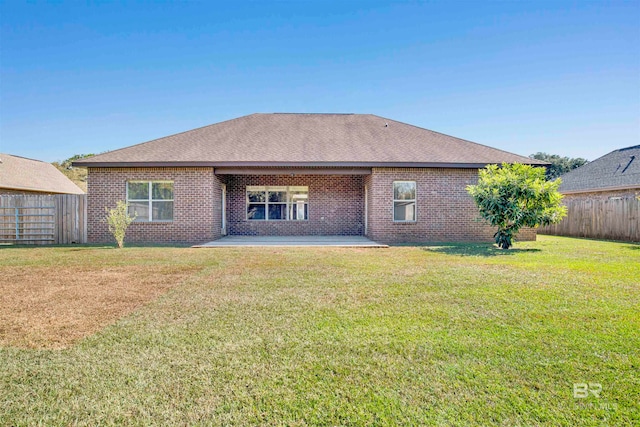 back of house featuring a patio and a lawn