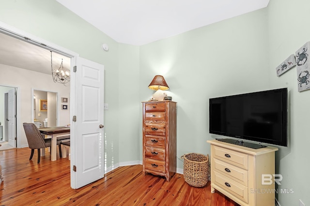 interior space featuring an inviting chandelier and light hardwood / wood-style flooring