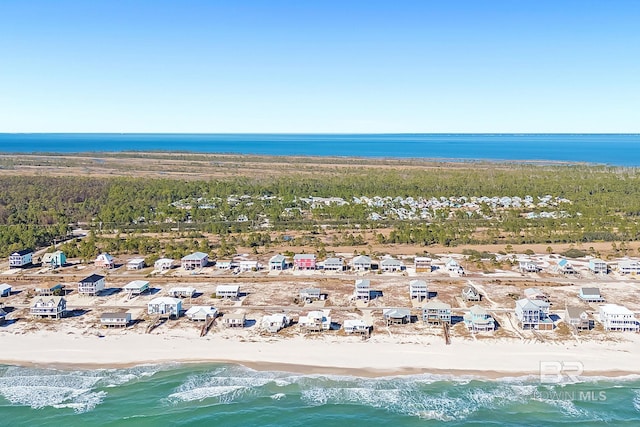 birds eye view of property with a beach view and a water view