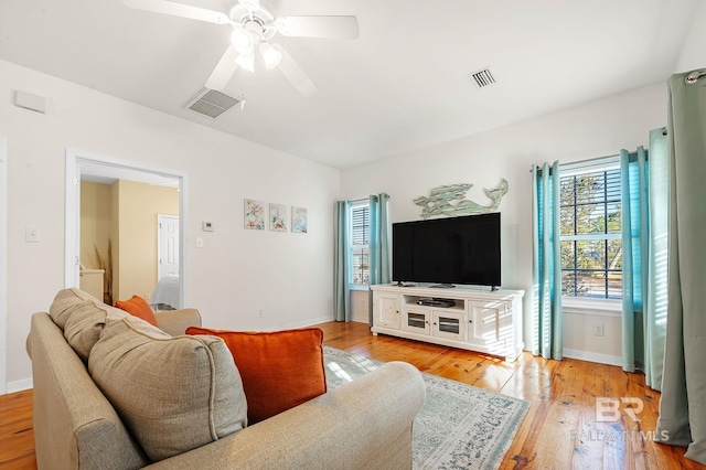 living room featuring ceiling fan and light wood-type flooring