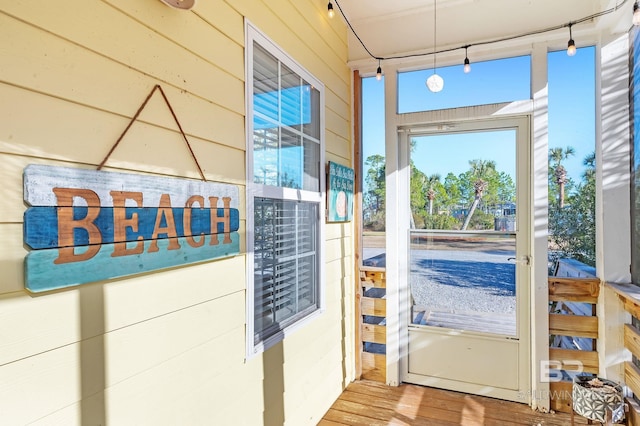 entryway featuring hardwood / wood-style flooring and wood walls