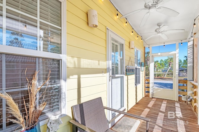 sunroom featuring ceiling fan