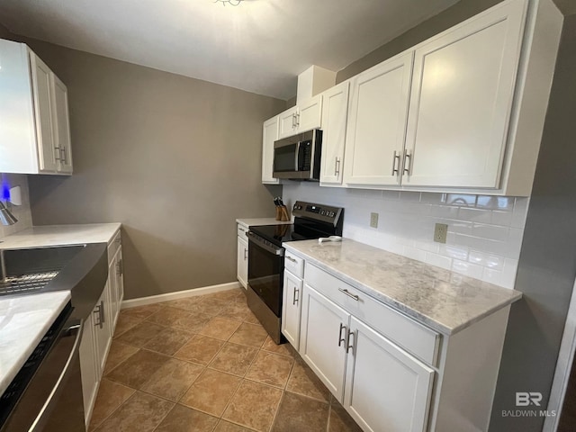 2274 Foshee Rd, Brewton, AL 36426 - kitchen featuring stainless steel appliances, white cabinetry, backsplash, and light stone counters