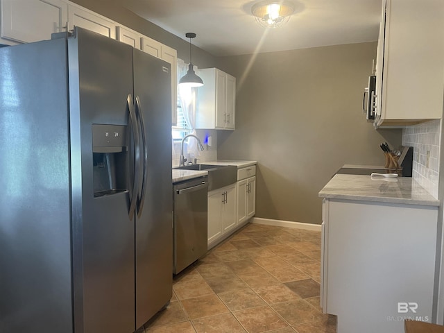2274 Foshee Rd, Brewton, AL 36426 - kitchen with stainless steel appliances, white cabinetry, tasteful backsplash, and decorative light fixtures