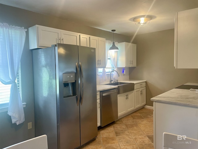 2274 Foshee Rd, Brewton, AL 36426 - kitchen featuring stainless steel appliances, white cabinetry, pendant lighting, and light stone counters
