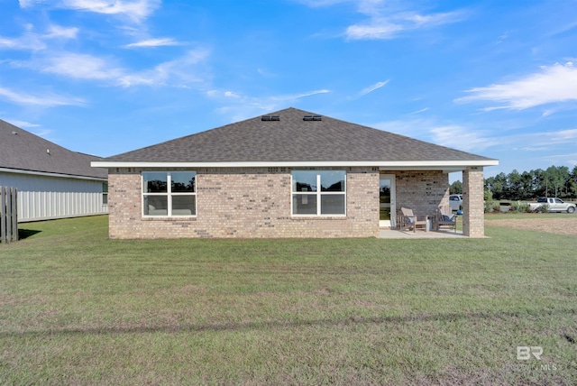 back of house featuring a patio area and a yard