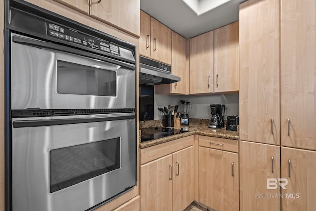 521 W Beach Blvd Unit 1702, Gulf Shores, AL 36542 - kitchen with stainless steel double oven, light brown cabinets, under cabinet range hood, and black electric cooktop