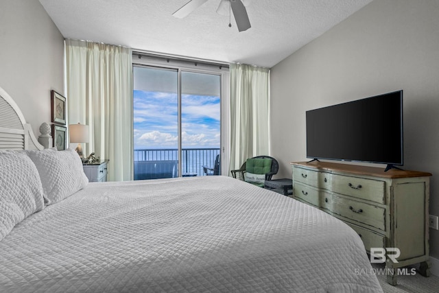 521 W Beach Blvd Unit 1702, Gulf Shores, AL 36542 - bedroom with access to exterior, expansive windows, a textured ceiling, and a ceiling fan