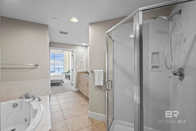 521 W Beach Blvd Unit 1702, Gulf Shores, AL 36542 - full bathroom featuring a stall shower, a tub with jets, vanity, ensuite bath, and tile patterned flooring